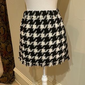 Houndstooth skirt with fringe.